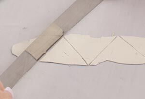 Clay being cut into triangles